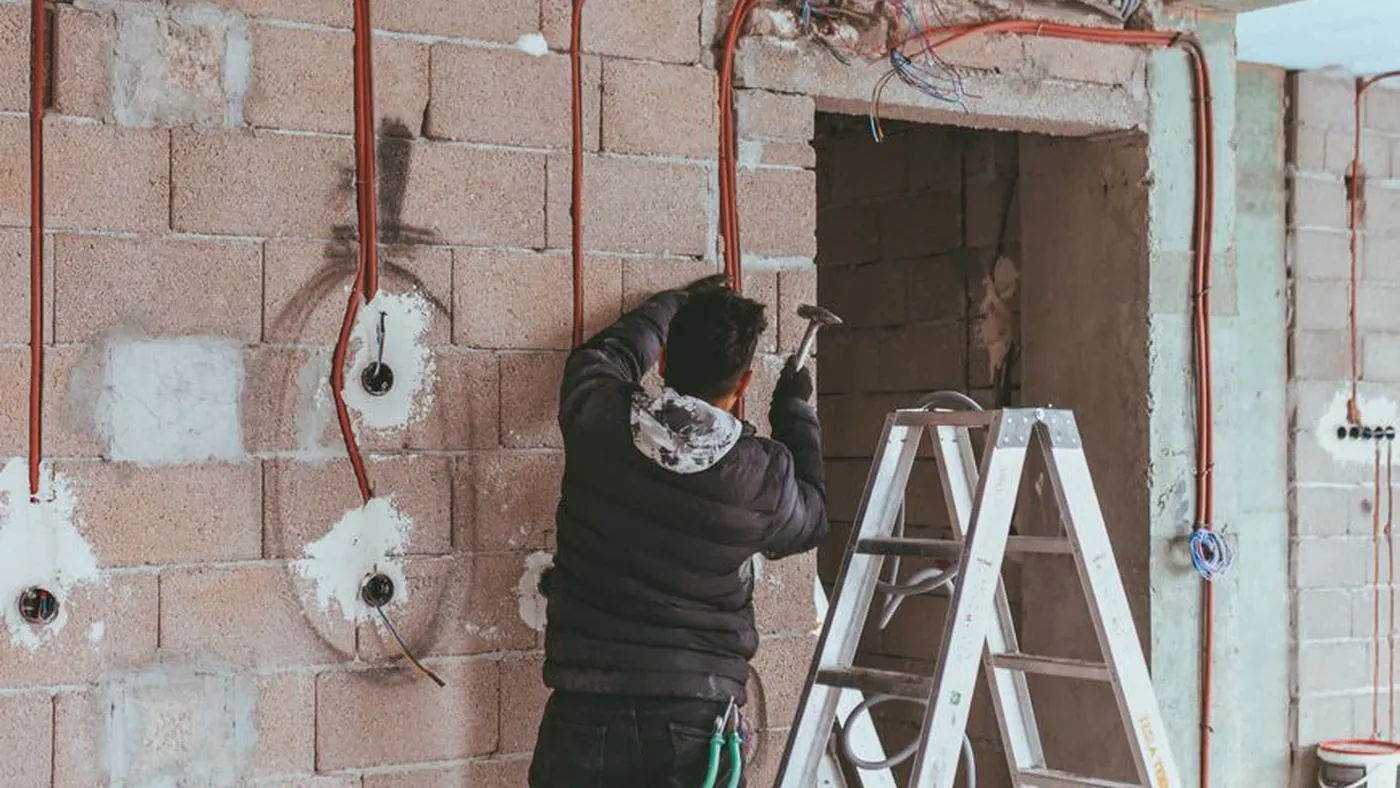 Electrician installing cables in a home